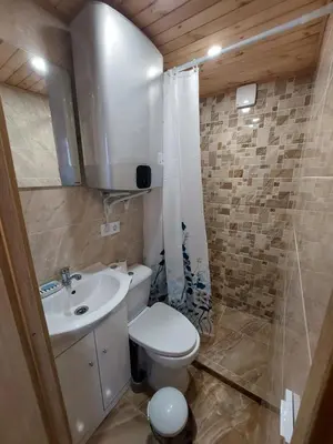 a small bathroom with a toilet and a sink at Pasakų pirtelė in Vilnius