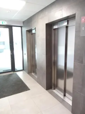 a hallway with elevators in a building at Apartments with an impressive terrace on the roof of the house in Vilnius