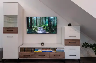 a living room with a tv on a wall at Bravo Apartments in Kaunas