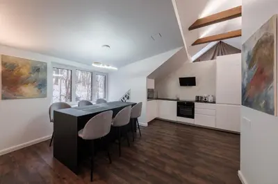 a kitchen and dining room with a table and chairs at Bravo Apartments in Kaunas