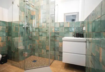 a bathroom with a glass shower with a toilet at Central Station Apartment No5 in Kaunas