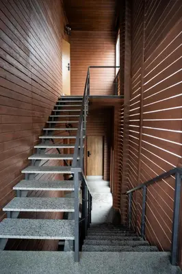 a staircase in a building with a wooden wall at Central Station Apartment No4 in Kaunas