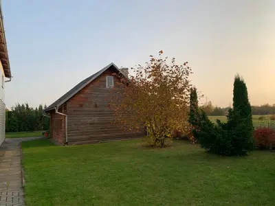 an old wooden barn in a grassy yard at Saldus sapnas in Rokiškis