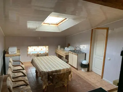 a kitchen with a table and a sink in a room at Saldus sapnas in Rokiškis