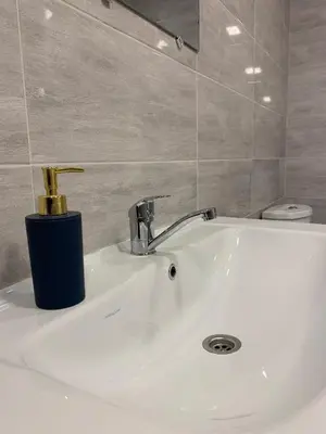 a bathroom sink with a soap dispenser on top of it at Saldus sapnas in Rokiškis