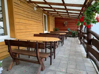 a row of tables and benches on a patio at Saldus sapnas in Rokiškis