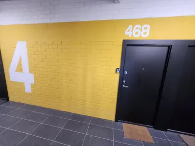 a yellow brick wall with a door at Radio city loft-468 in Kaunas