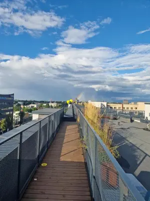a walkway on a balcony with a view of a city at Radio city loft-468 in Kaunas