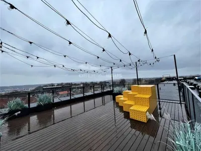 a group of yellow chairs sitting on a deck at Radio city loft-468 in Kaunas