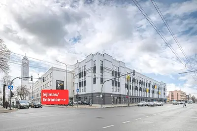 a large white building on a city street at Radio city loft-468 in Kaunas