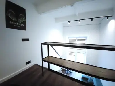 an empty room with a staircase in a building at Radio city loft-468 in Kaunas