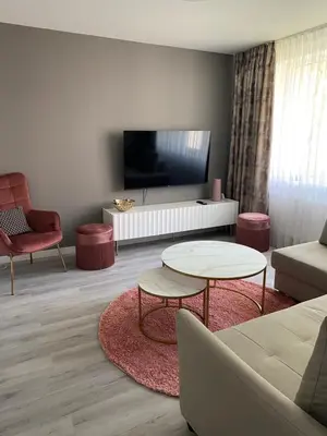 a living room with a couch and a table at Marijos apartamentai in Birštonas