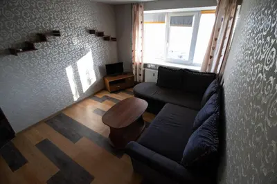 a living room with a couch and a table at Jaukus butas pačioje miesto širdyje in Šiauliai