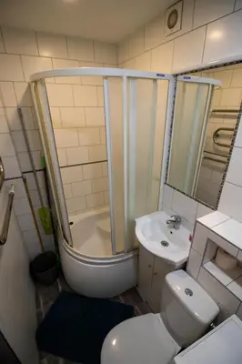a bathroom with a shower and a toilet and a sink at Jaukus butas pačioje miesto širdyje in Šiauliai