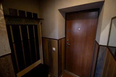 a room with a wooden door and a wooden cabinet at Jaukus butas pačioje miesto širdyje in Šiauliai