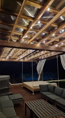 a room with a swing with a bed in it at Poilsiaviete Vakaris in Gudeliai