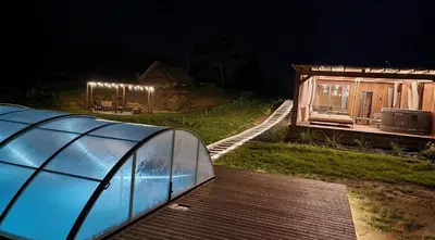 a small house with a glass dome on a deck at Poilsiaviete Vakaris in Gudeliai