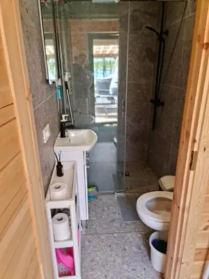 a bathroom with a shower and a toilet and a sink at Poilsiaviete Vakaris in Gudeliai