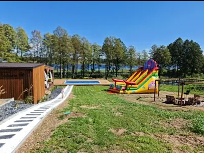 a playground with a slide in a park at Poilsiaviete Vakaris in Gudeliai