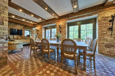 a dining room with a table and chairs at Užutrakio rezidencija in Trakai