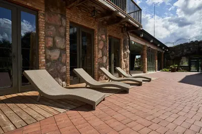 a row of chairs sitting outside of a building at Užutrakio rezidencija in Trakai
