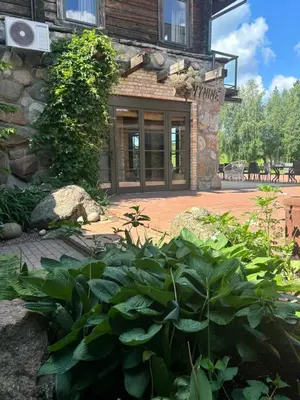a garden in front of a stone building at Užutrakio rezidencija in Trakai