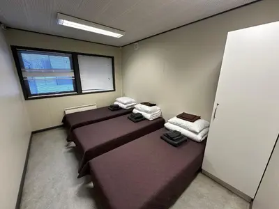 a room with three beds and a window at Dvaro namai in Norgėlai