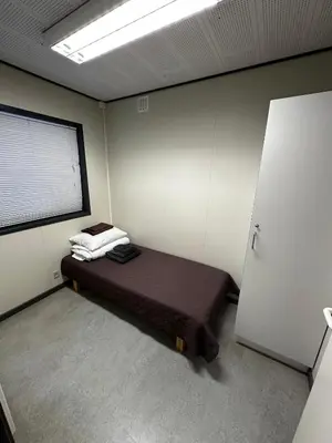 a bedroom with a bed in a room with a window at Dvaro namai in Norgėlai