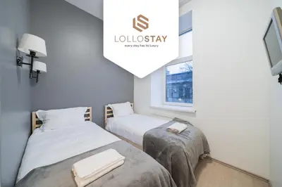 a room with two beds and a window at Halės Self Check-in Guest House - Lollo Stay in Vilnius