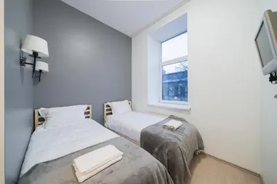 two beds in a small room with a window at Halės Self Check-in Guest House - Lollo Stay in Vilnius
