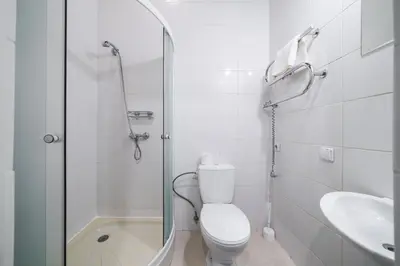 a bathroom with a shower and a toilet and a sink at Halės Self Check-in Guest House - Lollo Stay in Vilnius