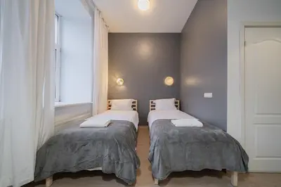 two beds in a room with a window at Halės Self Check-in Guest House - Lollo Stay in Vilnius