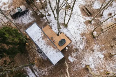 an overhead view of a shed and a car on the ground at Living art piece at the lake. in Užutrakis