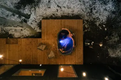 a person in a bath room with a mirror at Living art piece at the lake. in Užutrakis