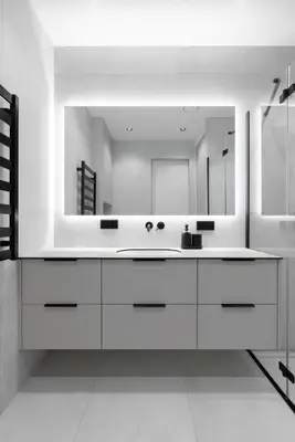 a bathroom with a sink and a large mirror at Hygge Sand Apartment in Vilnius