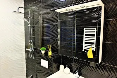 a bathroom with a mirror and a sink at Nauji apartamentai su kiemeliu in Kaunas