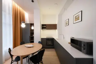 a kitchen with a table and chairs in a room at Downtown getaway apartments by Prime Rentals I in Kaunas