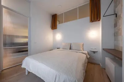 a bedroom with a white bed and a window at Downtown getaway apartments by Prime Rentals I in Kaunas