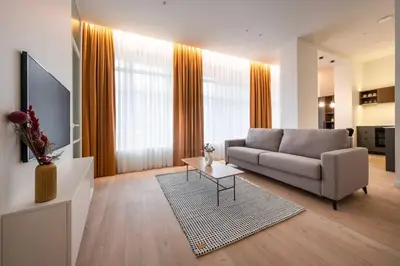 a living room with a couch and a table at Downtown getaway apartments by Prime Rentals I in Kaunas