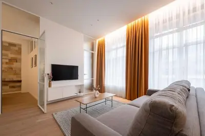 a living room with a couch and a tv at Downtown getaway apartments by Prime Rentals I in Kaunas
