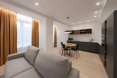 a living room and kitchen with a couch and a table at Downtown getaway apartments by Prime Rentals IV in Kaunas