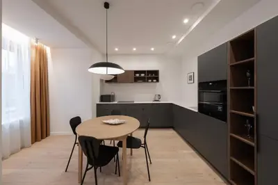 a kitchen and dining room with a table and chairs at Downtown getaway apartments by Prime Rentals IV in Kaunas
