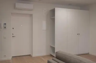 a living room with white walls and a couch at Downtown getaway apartments by Prime Rentals IV in Kaunas