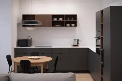a kitchen with a table and a kitchen with a counter at Downtown getaway apartments by Prime Rentals IV in Kaunas