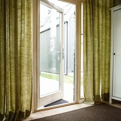 an open sliding glass door with a window at Domi Lini in Druskininkai