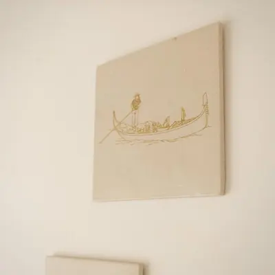 a drawing of a man in a boat on a wall at Domi Lini in Druskininkai