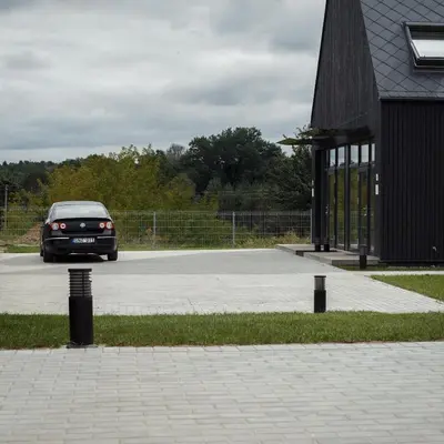 a car parked in a parking lot next to a building at Domi Lini in Druskininkai