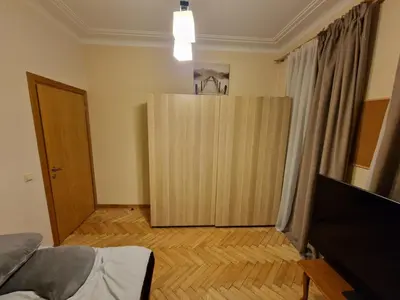 a room with a large wooden door in a room at Kaunas Center Apartment in Kaunas