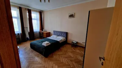 a bedroom with a bed in the middle of a room at Kaunas Center Apartment in Kaunas