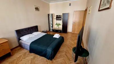 a bedroom with a bed and a television in it at Kaunas Center Apartment in Kaunas